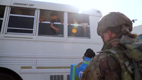 Afghan-Refugees-Make-It-To-Safety-And-Are-Ushered-Onto-Planes-By-Us-Soldiers-At-Hamid-Karzai-Airport-During-The-Mass-Evacuation-Effort-Of-Afghanistan