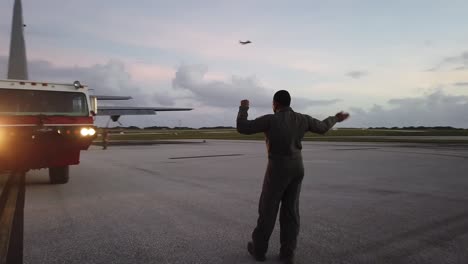 A-Us-Air-Force-Airman-On-Andersen-Air-Force-Base-Tarmac-Loads-Fire-Engine-Onto-C-130-Hercules-Airplane,-Guam