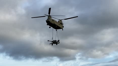 Slow-Motion,-Us-Army-Ch-47-Chinook-Helicopter-Sling-Loads-M777-Howitzer-During-Troop-Support-Military-Exercise