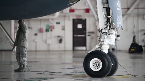 A-Ground-Crew-Maintains-And-Directs-A-Northrop-B-2-Spirit-Stealth-Bomber-While-In-A-Hanger-And-Taxing-On-A-Runway