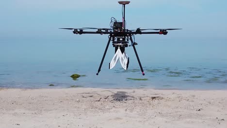 Aerial-Drone-Footage-Of-High-Technology,-Ground-Penetrating-Radar-Sky-Glass-Mounted-On-A-Drone,-Flys-Test-Patterns-On-A-Beach-In-Kiel,-Germany