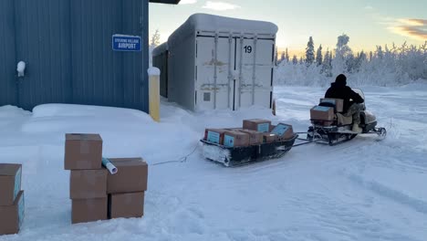 Alaska-National-Guard-Crew-Unload-Plane,-Helicopter,-Use-Snowmobile-To-Deliver-Christmas-Gifts-To-Children-In-Remote-Villages