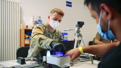 Us-Army-Soldiers-At-Ramstein-Afb-Screen-Afganistan-Evacuees-During-The-Vetting-Process-During-Operation-Allies-Refuge