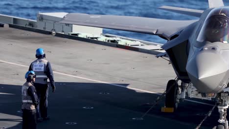 Italian-Jet-Fighter-Refuels-And-Taxis-During-A-Cross-Dock-Operation,-Hms-Queen-Elizabeth-And-Its-Cavour,-Mediterranean-Sea