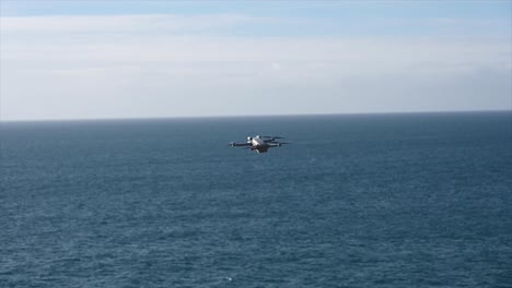 a-drone-flies-stationary-above-the-english-channel,-filmmaking-gear-with-propellers