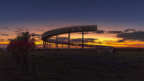 Time-lapse-captured-at-Kobyli-lookout-point-A-wooden-spiral-construction-in-the-South-Moravia-region-during-sunset-with-moving-clouds-and-views-of-the-exuberant-farms-and-fields