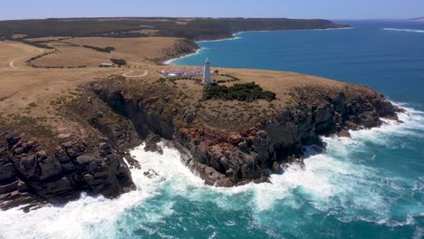 Kangaroo-Island-Cape-Willoughby-Lighthouse-vertical-aerial-with-crashing-waves-at-daytime,-South-Australia