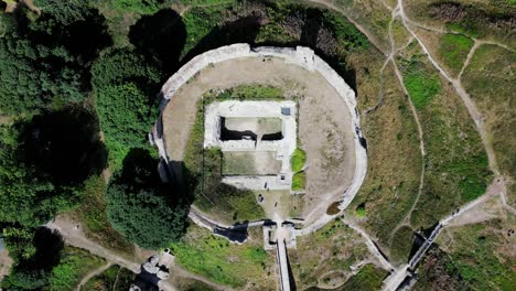 Vertical-Aerial-view-of-12th-Century-Castle-Acre-ruins,-Norfolk,-UK