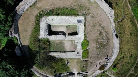 Vertical-Aerial-view-of-12th-Century-Castle-Acre-ruins,-Norfolk,-UK