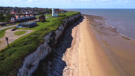 Aerial-view-of-Hunstanton-beach,-cliff-face-and-lighthouse