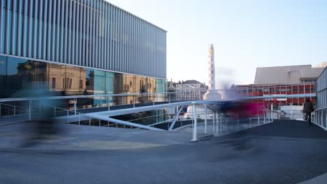 Bicycle-commuters-rush-past-up-and-down-the-spiral-ramp-at-Leuven-Station,-Belgium,-timelapse