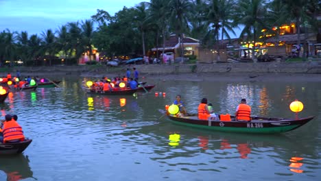 Panning-shot-of-tourists-on-small-boats-with-colourful-laterns-in-Hoi-An---Vietnam