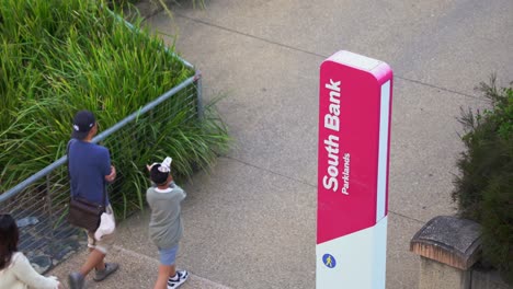 Friends-and-family-hangout-place,-people-walking-and-strolling-at-south-bank-parklands,-fitness-person-jogging-on-riverside-promenade,-recreational-precinct-at-Brisbane-city,-Queensland,-Australia