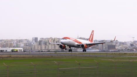 Aterrizar-Y-Aterrizar-Con-Humo-De-Los-Neumáticos-De-Un-Easyjet-Airbus-A320-En-El-Aeropuerto-De-Faro-En-Portugal