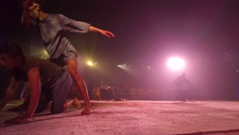 Group-of-dancers-rehearsing-a-performance-for-a-private-event-jumping,-running-and-doing-dramatic-movements