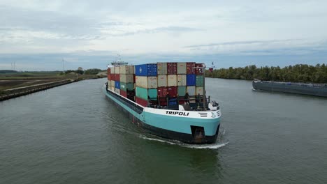 Aerial-View-Of-Tripoli-Cargo-Ship-Navigating-Oude-Maas-Through-Puttershoek