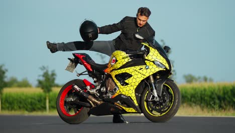 Middle-age-Man-Motorcyclist-Goes-to-His-BMW-Motorcycle,-Sits-on-it-And-Puts-on-Helmet-in-Rural-Berlin