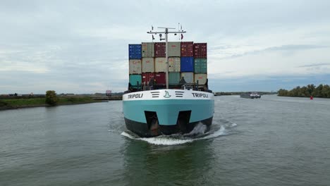 Aerial-View-Off-Forward-Bow-Of-Tripoli-Cargo-Ship-Navigating-Oude-Maas-In-Puttershoek