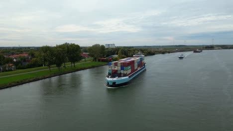 Zwijndrecht,-Belgium---23-September-2022:-Cargo-ship-sailing-on-Schelda-river-in-Zwijndrecht,-Belgium-freighting-containers