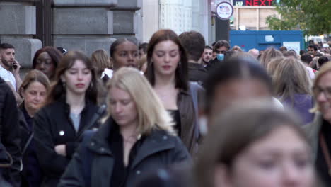 People-walk-along-a-busy-on-Oxford-Street-during-the-day