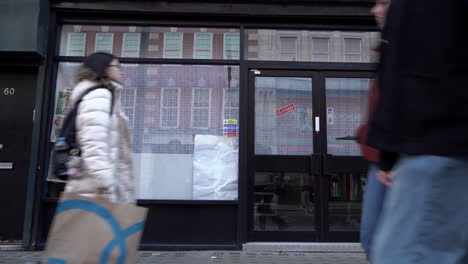 Menschen-Gehen-In-Zeitlupe-An-Einer-Leeren-Geschäftsfläche,-Bekannt-Als-„tote-Räume“,-Auf-Der-Tottenham-Court-Road-Vorbei