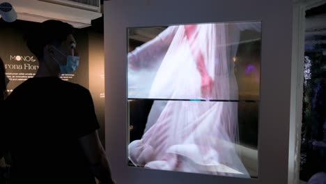 Chinese-visitors-look-at-digital-artworks-during-the-Digital-Art-Fair-showcasing-interactive-Web-3