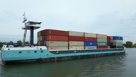 Drone-View-Of-Starboard-Side-Of-Tripoli-Cargo-Ship-Navigating-Oude-Maas-Through-Puttershoek