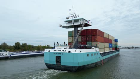 Aerial-View-From-Stern-Of-Tripoli-Cargo-Ship-Navigating-Oude-Maas-Through-Puttershoek