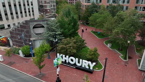 Rotational-aerial-shot-of-Khoury-School-of-Computer-Sciences-sign-on-college-campus