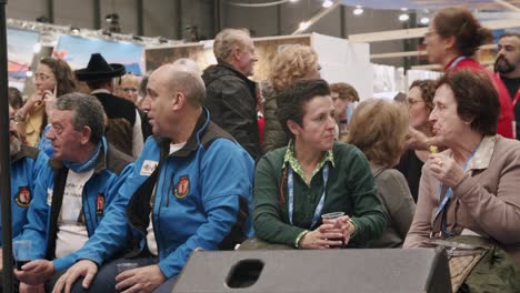 Motion-shot,-seated-audience-waiting-for-seminar,-eating-and-drinking,-Madrid,-Spain