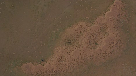 Drone-shot-of-the-Namib-Naukluft-National-Park-in-Namibia---drone-is-flying-over-the-beautiful-sandy-steppe