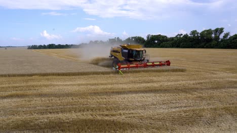 A-combine-harvester-harvests-wheat-crops-fields-during-the-summer-in-Ukraine