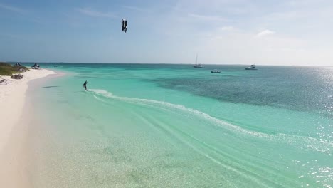 Drone-shot-sunset-MAN-KITESURF-ALONG-COASTLINE-CRASQUI-ISLAND-Los-Roques