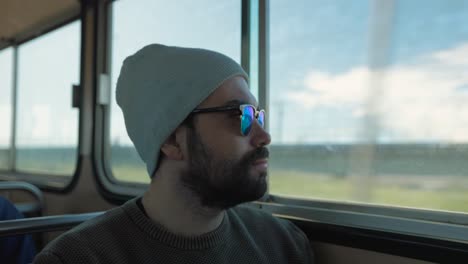 Passenger-man-on-a-transit-bus-Looking-out-window