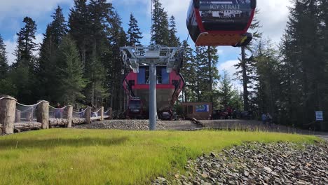 Doppelmayr-Lift-Systems-gondolas-in-Icy-Strait-Point,-Hoonah,-Alaska-unload-station-with-gondalas-passing-overhead