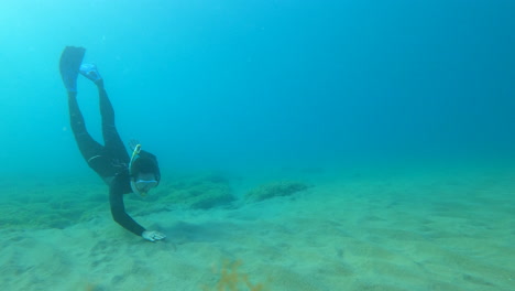 Person-Seen-Snorkelling-Towards-Sea-Floor-And-Swimming-Past