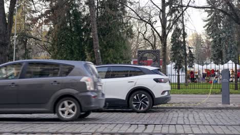 Focused-shot-of-modern-electric-car-charging-in-power-station-in-the-street