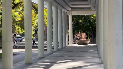 People-are-filling-bottles-with-warm-mineral-water-at-the-fountain-at-the-colonnade-of-the-Mоmina-sаlza-spring