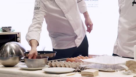 Two-chefs-examining-ingredients-before-presenting-at-tourism-seminar,-Madrid,-Spain