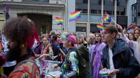 Colorful-parade-of-Oslo-Pride-2022-in-city-downtown-streets,-side-view