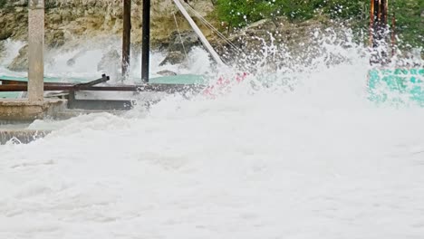 Telezoom-of-local-wooden-fishing-boat-being-smashed-into-pieces-during-sudden-storm-with-rough-waves,-Caribbean