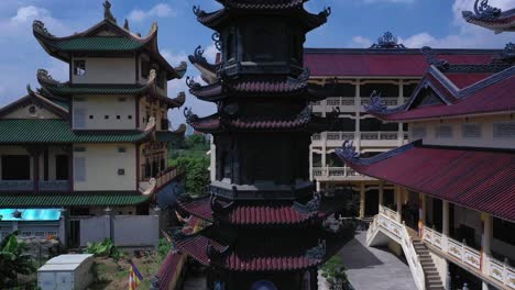 Aerial-shot-of-colorful-Buddhist-temple-on-sunny-day-with-blue-sky