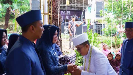 The-groom-kisses-the-hands-of-the-bride's-parents