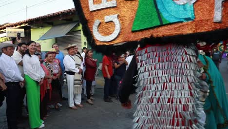 People-Watching-The-Two-Men-In-Traditional-Costume-And-Mask-Re-enact-The-Sword-Fight-During-Ancestral-Dance-Event-In-Tuxpan,-Jalisco,-Mexico