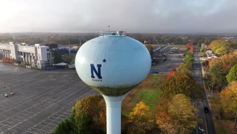 Navy-water-tower-and-football-field-in-Annapolis-Maryland,-home-of-USA-military-Naval-Academy-to-train-midshipmen-and-Marine-Corps-cadets