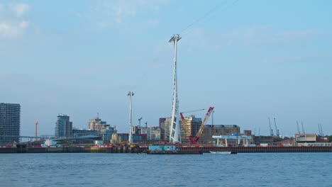 Pylons-Of-IFS-Cloud-Cable-Car-Seen-Across-River-Thames-At-The-London-Docklands-In-London,-UK