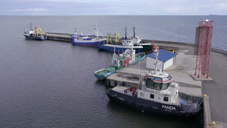 Mooring-tug-trawl-boats-in-docking-pier-summer-day,-static,-wide-shot