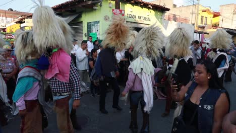 Indigenous-People-In-Costumes-Dancing-In-The-Street-Of-Tuxpan-During-XXIV-Meeting-Of-Ancestral-Dances-Celebration-In-Jalisco,-Mexico