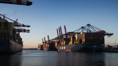 Large-container-vessels-in-the-port-of-Hamburg,-4K-time-lapse-from-day-to-night,-slow-zoom-out,-clean-sky,-economy,-export,-market,-symbol