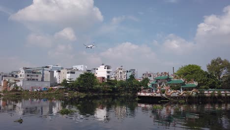 Airplane-flying-low-over-Phu-Chau-pagoda-or-floating-temple